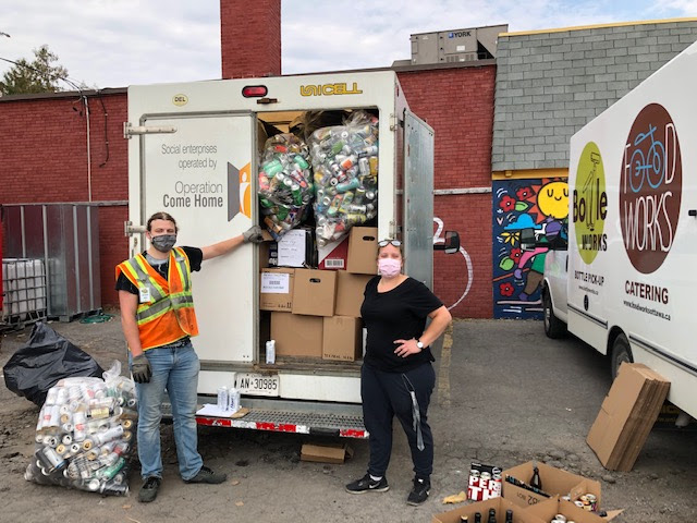 Workers showing bottles in a truck for the Bottle Drive for Operation Come Home event